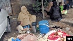 Burqa clad women waiting to get out of Bajaur last month.