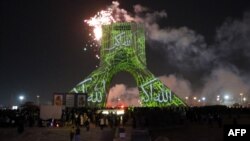 Iranians watch fireworks around the Azadi (Freedom) Tower during a ceremony marking the 45th anniversary of the Islamic Revolution in Tehran on February 10.