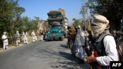 Pro-Taliban militants stand with their weapons on a street in the village of Manglor in Pakistan's Northwest Frontier Province. (file photo)