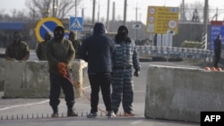 Pro-Russian gunmen at the Chongar checkpoint block the entrance to Crimea of OSCE monitors on March 7 -- a clear victory for Russia.