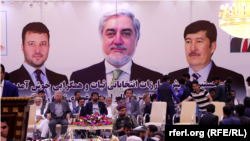 A campaign poster featuring Afghan CEO and presidential candidate Abdullah Abdullah (center) and his two running mates in Kabul on July 28.