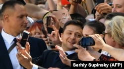 Volodymyr Zelenskiy takes selfies with supporters prior to his inauguration.