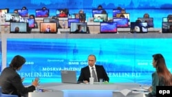 Russian President Vladimir Putin (center) during a previous question-and-answer live TV broadcast.