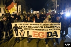 Marchers at Leipzig rally organized by LEGIDA, a local copycat of Dresden's right-wing populist movement Pegida (Patriotic Europeans Against the Islamization of the Occident).