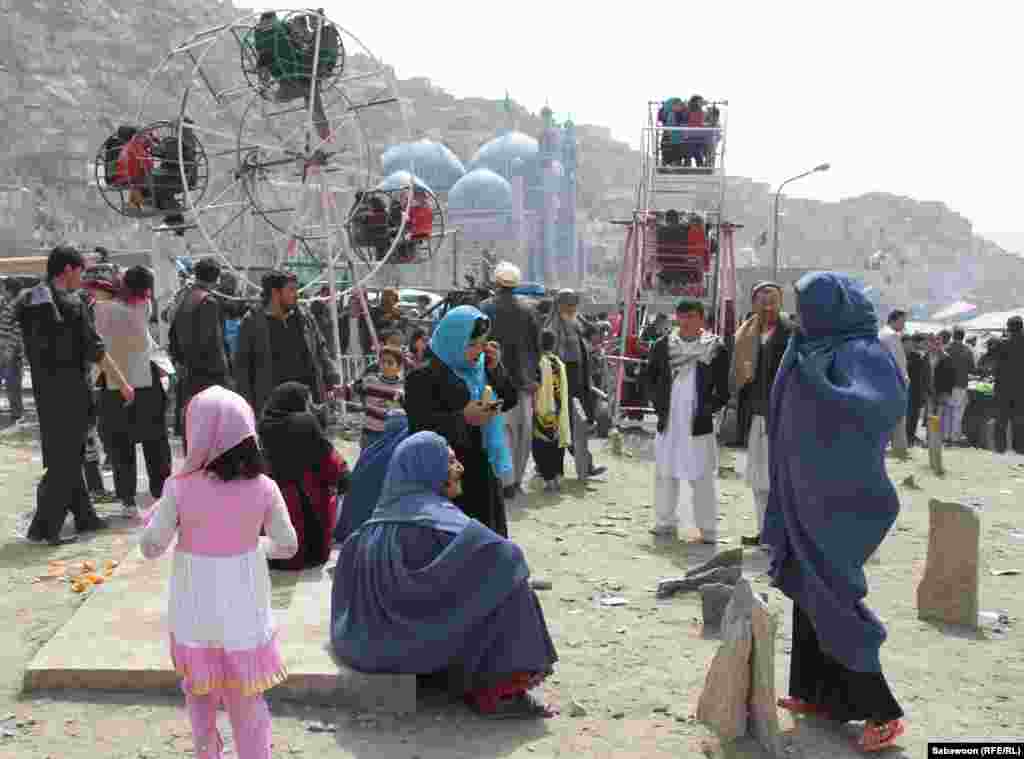 Kabul families attend an amusement park to enjoy the festivities.