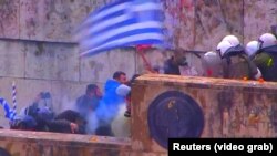 Demonstrators, angry at the proposed name change, face off against police in Athens on January 20. 