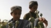 Children work in a poppy field in Helmand Province, where a mysterious disease has hit particularly hard. The province is home to a fertile river valley roughly the size of Switzerland that produces nearly half of the country's opium.