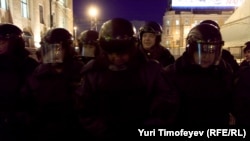 Russian OMON riot-police officers detain an opposition activist in Moscow.