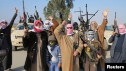 Tribal fighters gesture after deploying themselves on the streets of Ramadi on January 6.