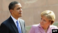 German Chancellor Angela Merkel and U.S. President Barack Obama inspect a military honor guard in Baden-Baden on April 3.