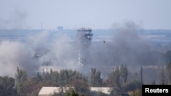 The traffic-control tower of Donetsk's Sergei Prokofiyev International Airport is seen through smoke during fighting between pro-Russian rebels and Ukrainian government forces in Donetsk on October 3.