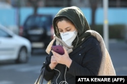 An Iranian woman checks messages on her smart phone in Tehran. “It’s like [authorities] are determined to fight the people.... [They] are happy about the torment they are inflicting on Iran," said Saeedeh Khashi, who lives in Sistan-Baluchistan, one of Iran’s poorest provinces. (file photo)