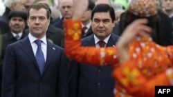 Turkmen President Gurbanguly Berdymukhammedov (center) and his Russian counterpart, Dmitry Medvedev, during a visit to a Russian school in Ashgabat today