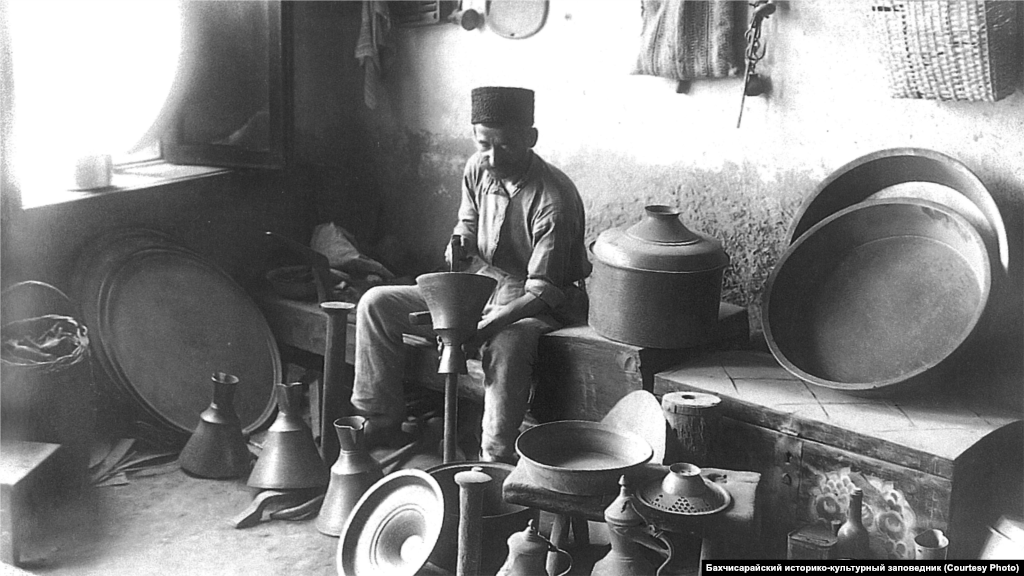 A coppersmith works in his shop in Bakhchysaray. Nonferrous metals were handled by coppersmiths. Household utensils were made of tin plated with copper, ritual vessels and chandeliers for mosques were made of brass. Coffee grinders were assembled from brass and iron parts.