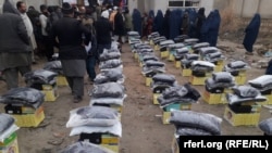 Afghans wait to receive parts of an aid shipment from China that includes food and and winter supplies in Kunduz on January 6.