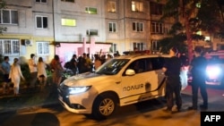 Journalists and police congregate at the entrance to the Kyiv building where journalist Arkady Babchenko was shot dead on May 29. 