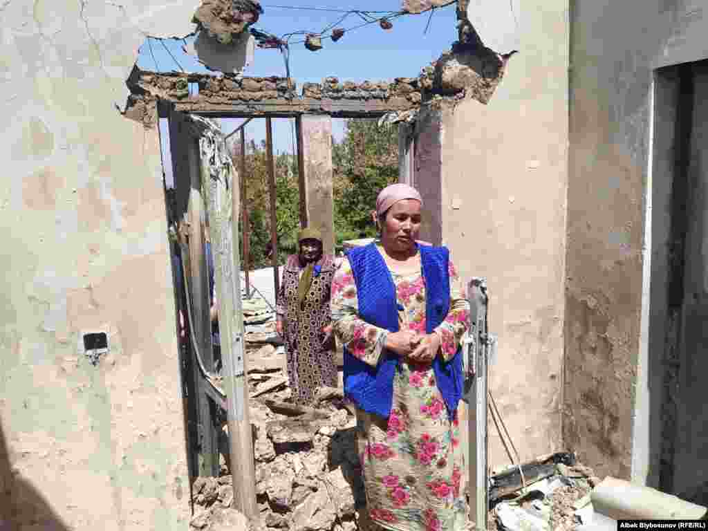 A woman stands in front of her destroyed home in the Kyrgyz village of Maksat. According to Bishkek, 78 private homes were destroyed in Kyrgyzstan&#39;s southwestern region of Batken.