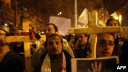 Egyptian Coptic Christians demonstrate outside the state radio and television building in central Cairo on March 8 to protest the burning of a church after deadly clashes between Christians and Muslims in a southern city.