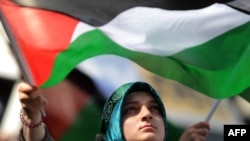 A demonstrator waves a Palestinian flag during an anti-Israeli protest in front of the Israeli Consulate in Istanbul on May 31.