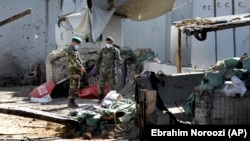 Afghan security forces work at the site of a suicide attack near the U.S. Embassy in Kabul on September 17.