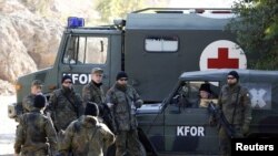 KFOR soldiers from Germany stand by their vehicles in the village of Jagnjenica near the town of Zubin Potok.