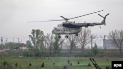 A Ukrainian military helicopter flies near a checkpoint near the eastern town of Slovyansk on May 2.