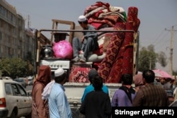 An Afghan man brings his household items to sell at a Kabul market on September 10, 2021. Afghans who plan to flee the country or are in need of cash to buy groceries and food resort to sell their belongings.