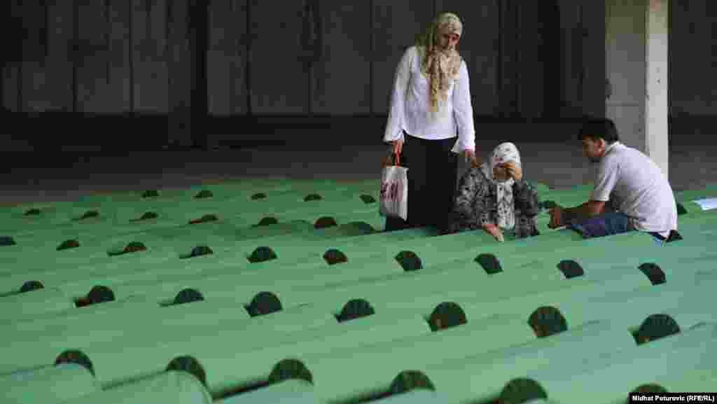 Mourners at one of the 520 coffins of newly identified victims of the 1995 Srebrenica massacre, which were laid out in Potocari on July 9.