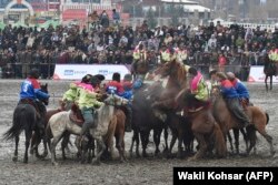 Horsemen compete during Afghanistan's first Buzkashi League, in Kabul in March.