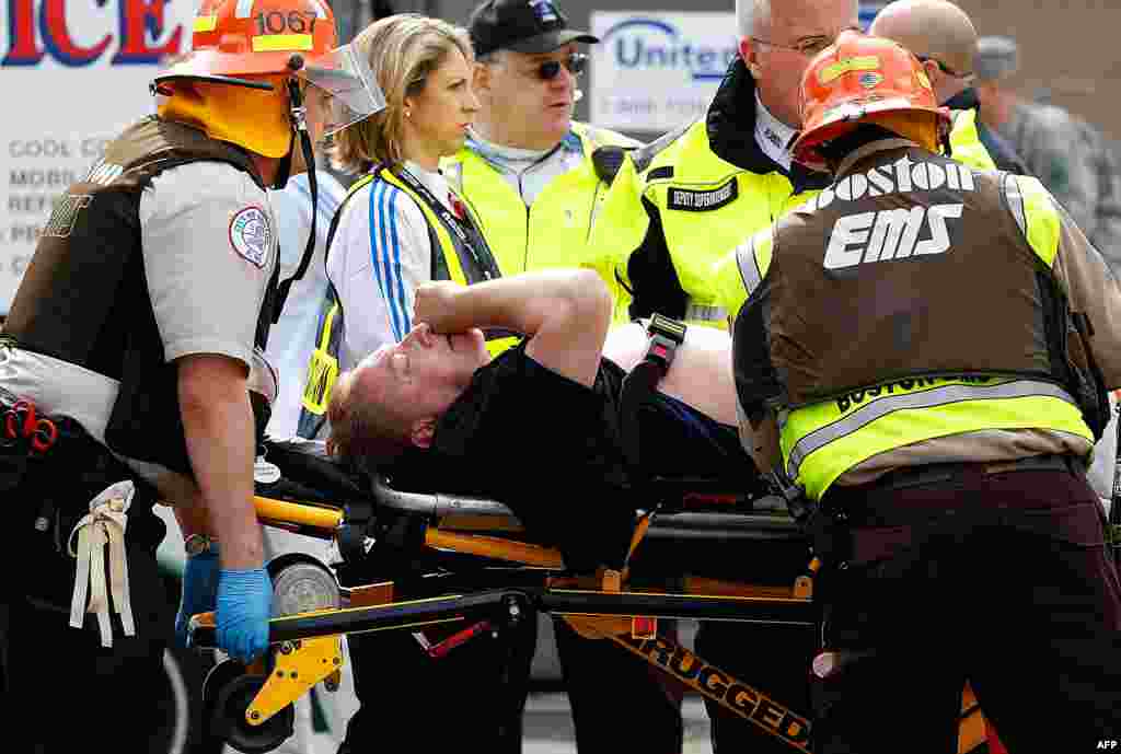 An injured man is lifted into an ambulance.