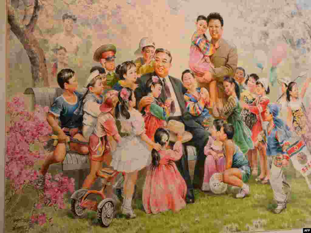 A painting featuring North Korean leaders Kim Il Sung (seated) and Kim Jong Il is on display during the opening of of Democratic People&#39;s Republic of North Korea state art exhibition &quot;Flowers of Kim Il Sung&quot; in Vienna in May 2010.