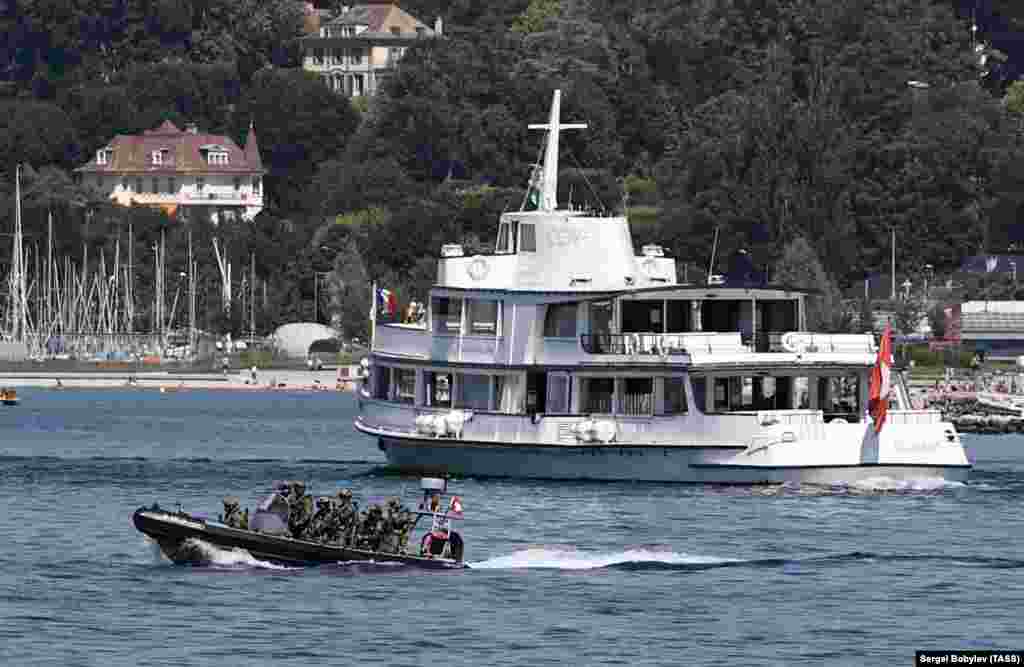 An inflatable boat filled with special forces patrols Lake Geneva on June 15.&nbsp;