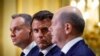 Polish President Andrzej Duda (left), French President Emmanuel Macron (center), and German Chancellor Olaf Scholz attend a joint press conference on June 12 at the Elysee Palace in Paris. 