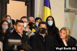 George Simion (left) and other AUR leaders talk to the press after their surprise showing in the parliamentary vote on December 7.