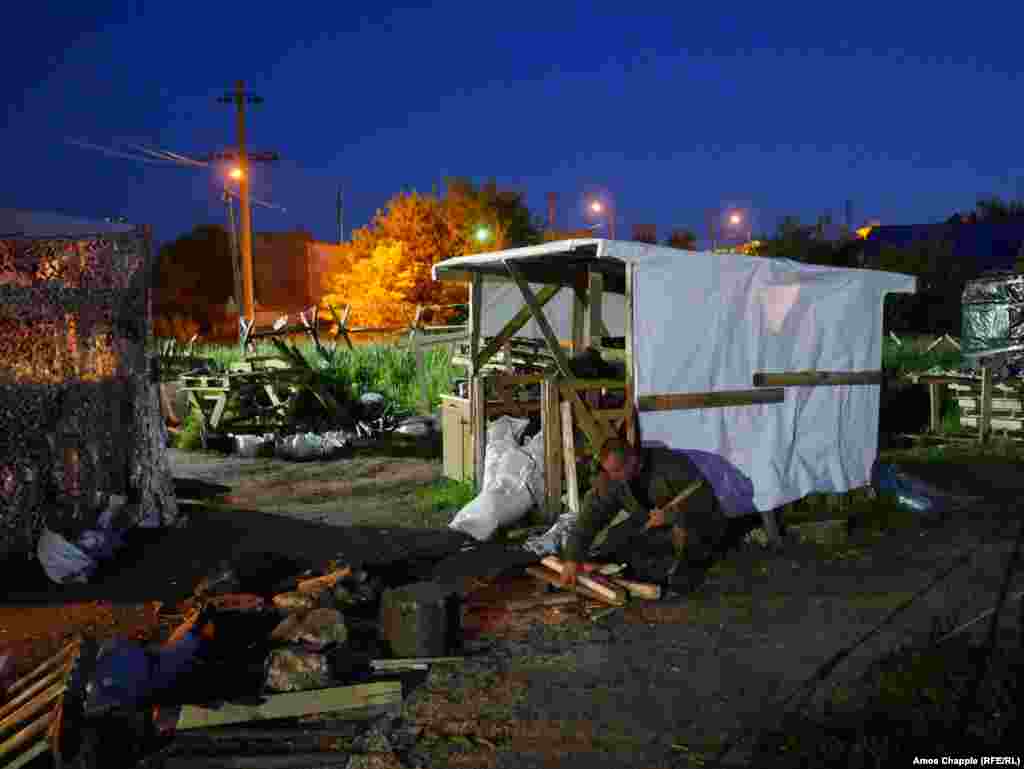 A blockader gathering firewood for the main sleeping tent. The activists declined to reveal details of the coming action, but the leader of the activists told a press conference they would target Russian-owned businesses in &quot;a way no one expects.&quot; &nbsp;