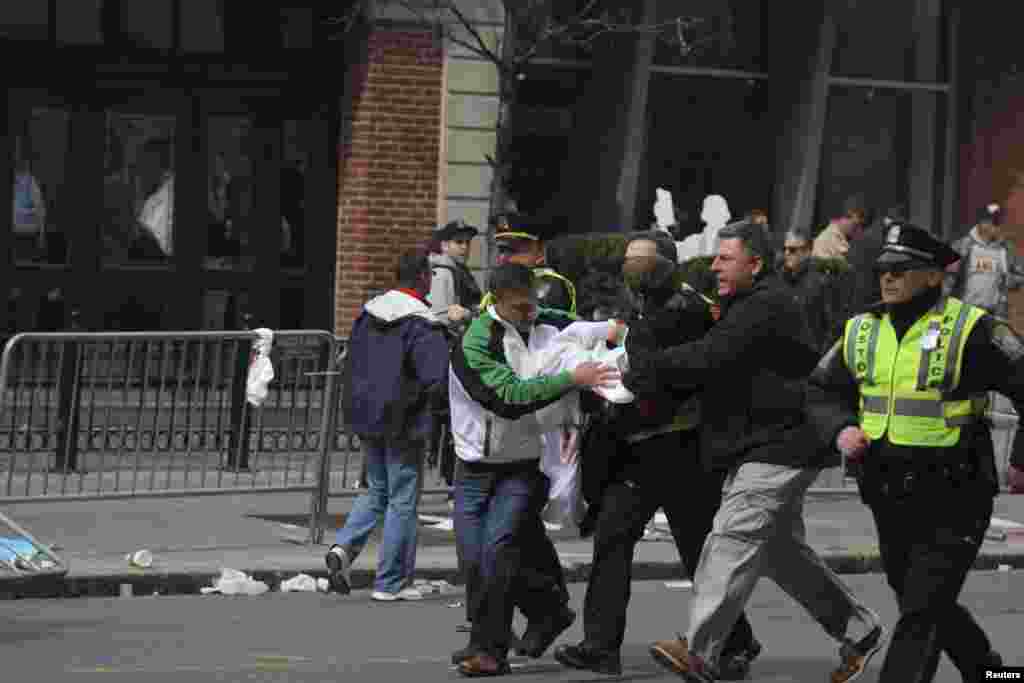 An injured victim is carried from the scene.