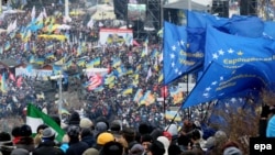 Protesters wave EU flags during a pro-European rally on Independence Square in Kyiv on December 8.