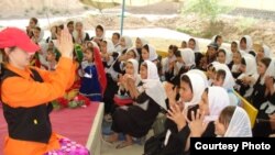 An actress from the Bond Street Theatre teaches pantomime to Afghan girls.