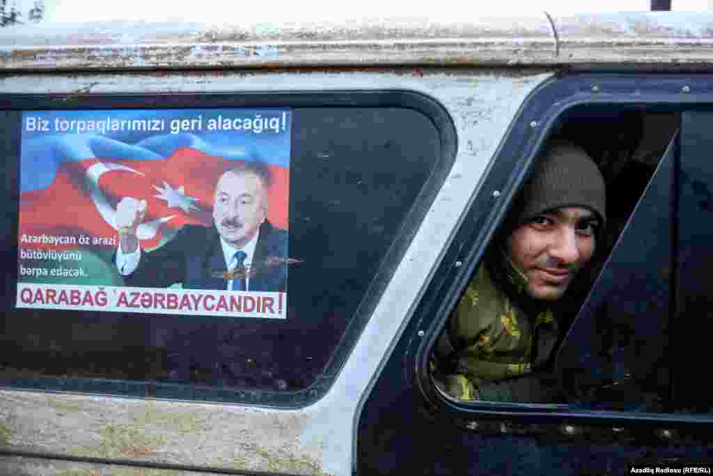 An Azerbaijani soldier sits inside a military vehicle in the recaptured city of Fuzuli.