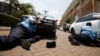 Kenyan police take cover outside the Westgate shopping center in Nairobi where gunmen from Somalia's Al-Qaeda-linked Al-Shabab movement went on a shooting spree on September 21.