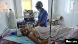 A nurse on December 19 attends to a man injured during the clashes in the city of Zhanaozen three days earlier.