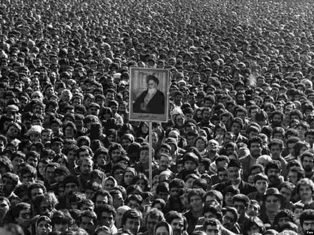 Protesters hold a portrait of Ayatollah Ruhollah Khomeini during the 1979 revolution.