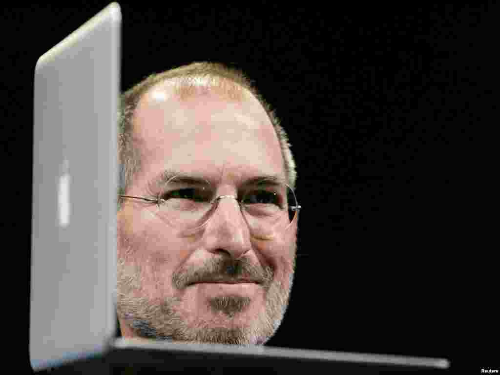 Jobs poses with a new product during the Macworld Convention and Expo in San Francisco in January 2008.