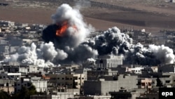 Smoke and flames rise following an apparent U.S.-led coalition air strike on Kobani on October 22.