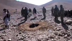 A video grab shows Afghan men stoning Rokhshana to death in Ghor Province in October 2015.