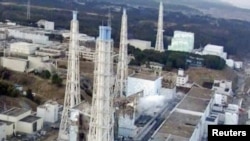 An aerial view shows damage sustained to the reactors at the Fukushima nuclear power complex.