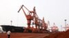 Bulldozers scoop soil containing various rare-earth elements to be loaded onto a ship at the port in Lianyungang, in China's eastern Jiangsu Province, for export to Japan.