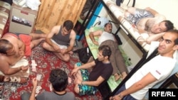 Iranian immigrants pass the time in a crowded hostel room in Dubai