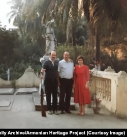 Russia’s ambassador to Bangladesh (left) holds Martin’s rifle as he poses for a photo with the couple.