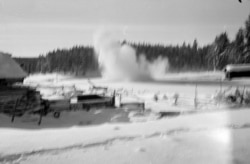 An artillery shell explodes near a farmstead during a Soviet advance.